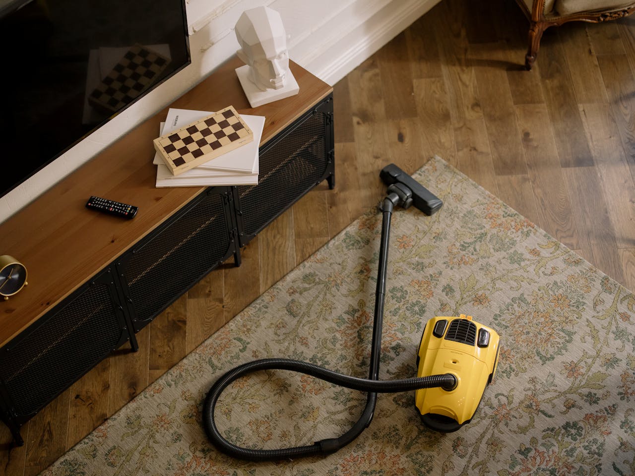 why-choose-us Warm living room scene featuring a yellow vacuum on a floral carpet with a vintage vibe.